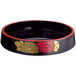 A black sushi tray with red and yellow floral decals.