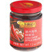 A jar of Lee Kum Kee Chiu Chow Chili Oil with whole red chili peppers and garlic inside.