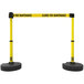Two yellow and black Banner Stakes safety tape stands.