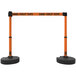 An orange and black Banner Stakes PLUS barricade system with "Danger - Forklift Traffic" tape.