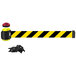 A black and yellow Banner Stakes wall mount barrier with a red light.