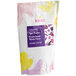 A white Bossen bag with purple and yellow dots containing purple sweet potato tiger powder mix.