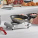 An Avantco single burner portable electric hot plate with an omelette cooking in a pan on a counter.