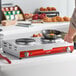 An Avantco double burner solid top portable electric stove with a pan cooking an egg.