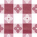 A red and white checkered Intedge vinyl table cover with flowers.