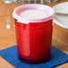 A close-up of a red Cambro plastic cup with red liquid in it.