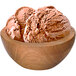 A wooden bowl filled with G.S. Gelato Chocolate Classico gelato on a table.