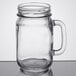 A Libbey glass mason jar with a handle on a table.