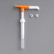 A white and orange Choice Maxi / Pelican condiment pump with two small white objects on the end.