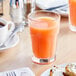 A glass of Ocean Spray grapefruit juice on a table.