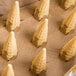 A group of JOY pointed bottom cake cones in a brown paper bag.