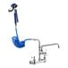 A white Waterloo wall-mounted pet grooming faucet with blue coiled hose attached.