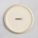 An Acopa Pangea fog white matte coupe porcelain plate with black text that says "Acopa"