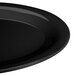 A close-up of a black oval platter with an elegant design.