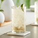 Two Acopa Pangea beverage glasses filled with iced tea, lime, and mint.
