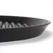 A black round HS Inc. Pizza Pleezer tray with a black rim and small holes in the bottom.
