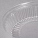 A Dart clear plastic dome lid on a clear plastic container.