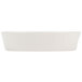 A white oval baker dish with a white background.