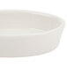 A Hall China ivory oval baker dish with a white background.