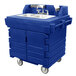 A navy blue plastic Cambro CamKiosk portable sink with two sinks on wheels.