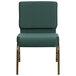 A green church chair with a green and gold dot patterned fabric and gold legs.