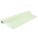 A roll of green and white polka dot paper table cover