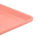 A close up of a pink Cambro dietary tray on a table.