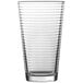 A clear glass mixing/pint glass with a thin line.