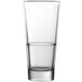 A Fortessa Basics Elixir cooler glass filled halfway with a clear liquid.