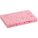 A pink Lavex cellulose sponge with small holes.