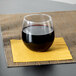 A Libbey stemless red wine glass of wine on a napkin.