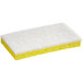 A yellow and white Lavex sponge with foam on top.