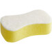 A yellow sponge with white foam on one side.