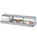 A Turbo Air stainless steel refrigerated sushi case with a curved glass door on a counter.