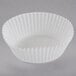 A close up of a white fluted baking cup.