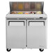 A Turbo Air stainless steel refrigerated sandwich prep table with two compartments.