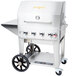 A silver Crown Verity barbecue grill with wheels and a stainless steel handle.