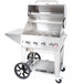 A Crown Verity stainless steel portable outdoor grill with wheels and an open lid.