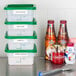 A stack of Cambro CamSquare white polyethylene food storage containers filled with food and spices.