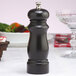 A Chef Specialties Salem ebony finish pepper mill on a table.