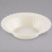 A Fineline Flairware ivory plastic bowl with a scalloped edge.