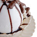 A Fineline Flairware ivory plastic bowl filled with white ice cream and chocolate syrup.