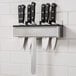 A stainless steel Edlund knife rack holding four knives on a counter.