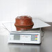 A chocolate cake on a Cardinal Detecto rotating ingredient scale.
