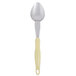 A Vollrath Jacob's Pride heavy-duty serving spoon with a yellow handle.