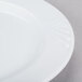 A close-up of a CAC white porcelain plate with a wavy design.