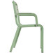 A sage green plastic armchair with a white background.
