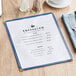 A blue Choice menu cover on a table.