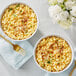 Two bowls of macaroni and cheese made with Follow Your Heart Vegan Shredded Cheddar Cheese.
