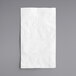 A white EcoChoice 2-ply bamboo dinner napkin on a gray surface.